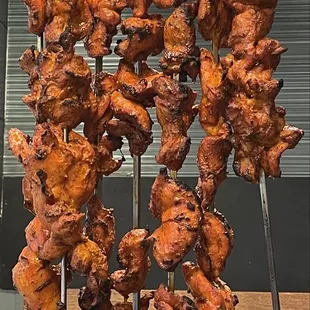 chicken skewers on a rack
