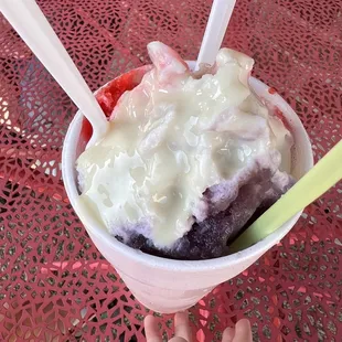 a hand holding a cup of ice cream