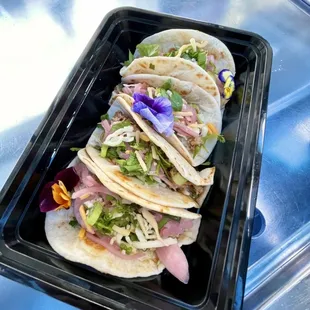 a tray of tacos on a table