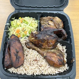 Jamaican jerk chicken with rice, beans, cabbage, fried plantain