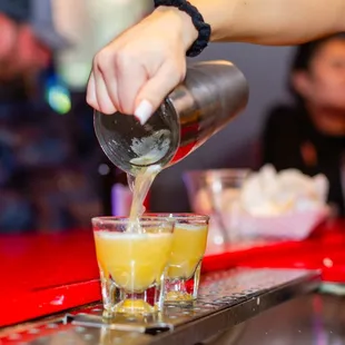 a bartender pouring a drink