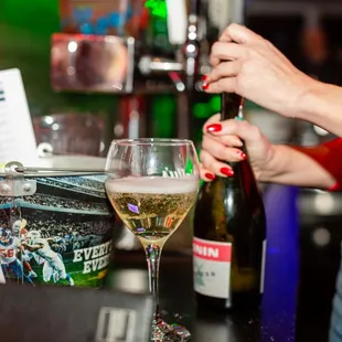 a woman pouring a glass of wine