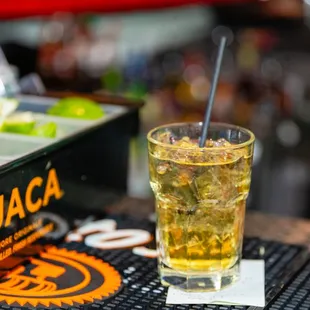 a glass of alcohol and a lemon