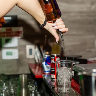 a female bartender pouring a drink