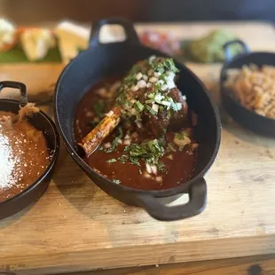 Birria bone-in beef shank | picaeta | cilantro | green onion escabeche | queso fresco | pico de gallo | guacamole