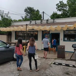 a group of people standing outside of a building