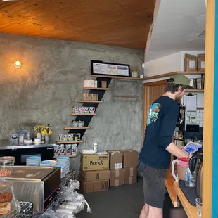 a man standing in a coffee shop