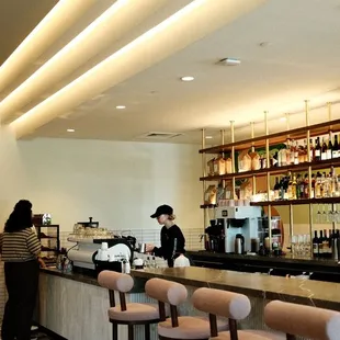 a woman standing at the bar