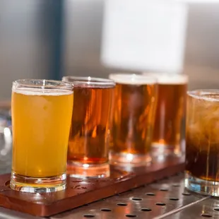 a row of beer glasses on a bar