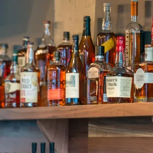 a shelf full of liquor bottles