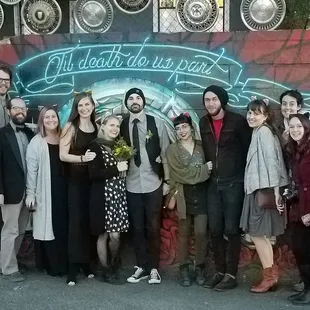 a group of people standing in front of a mural