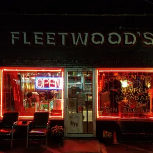 a neon lit storefront at night