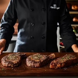 a chef preparing steaks