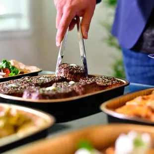 a man cutting a steak