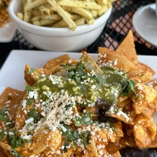 Chilaquiles with eggs. (Add more green sauce that's on the table for an even more amazing taste)