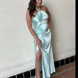 Aqua blue halter gown with slit, knotted detail, and asymmetrical lines.