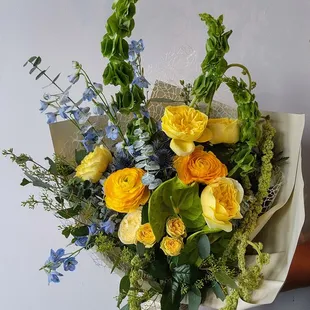 Forge + Bloom Wrap is a sophisticated floral arrangement that blends modern elegance with exotic allure.