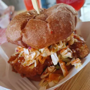 a chicken sandwich with coleslaw slaw