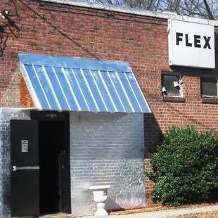 a brick building with a metal awning