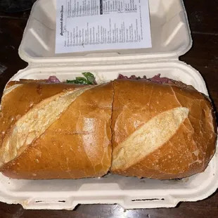 Pastrami and cheese sandwich with lots of toppings