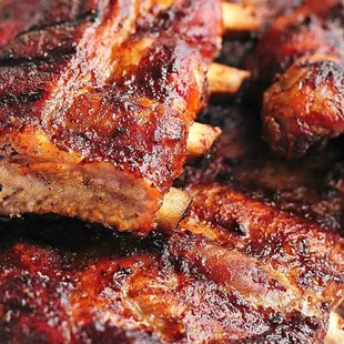 a close up of ribs on a plate