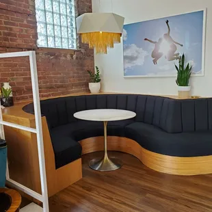 a corner booth with a table and chairs