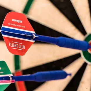 three darts in the center of a dart