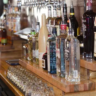 a row of liquor bottles on a bar