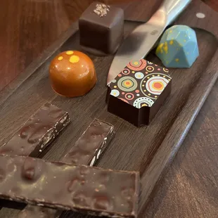 a chocolate bar, orange, and a knife