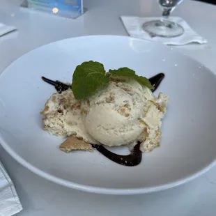 a plate of ice cream and chocolate sauce