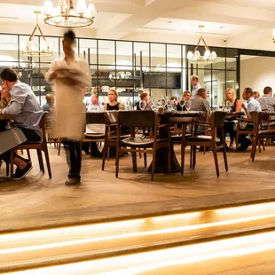 A buzzy, ambient upper dining room during dinner time.