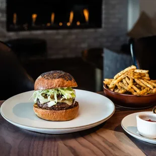 Flint&apos;s burger is sure to fan flames of desire with freshly ground chuck, smoked bacon jam, and gooey white cheddar on a poppy seed bun.