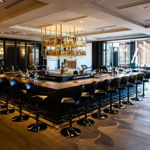 Enjoy bar food in a stunning, open space layout with a suspended brass bar display and two large screens streaming your favorite sports.