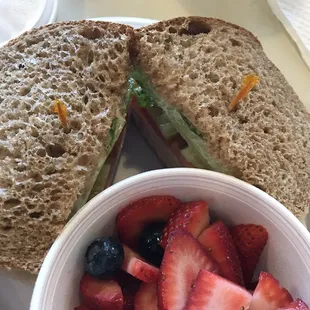 a sandwich with strawberries and blueberries