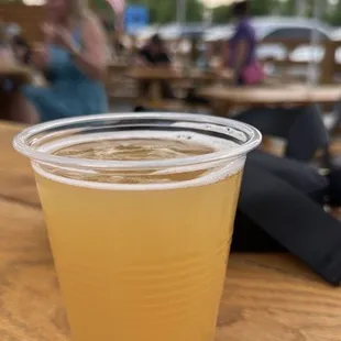 a plastic cup of beer on a table