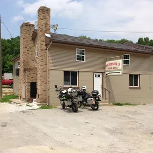 two motorcycles parked in front of a building