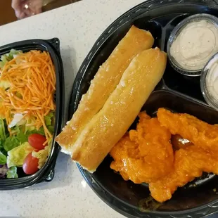 Chicken strips salad and breadsticks