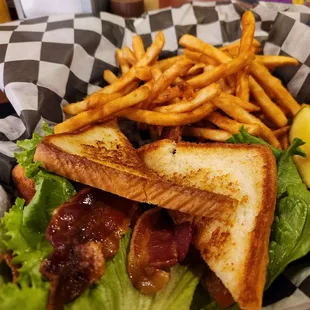 a sandwich and fries in a basket