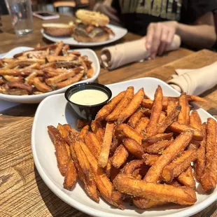a plate of french fries with dipping sauce