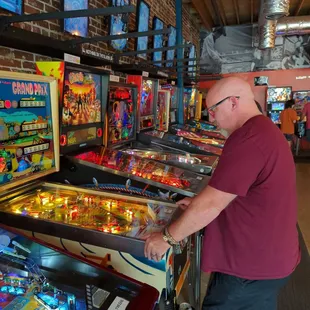 a man playing a game of pinball