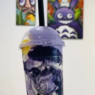 a hand holding a cup of boba