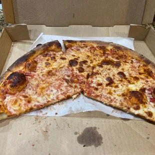 a half eaten pizza in a box