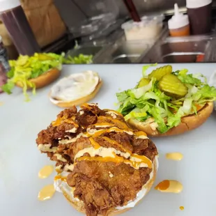 a chicken sandwich with lettuce and sauce