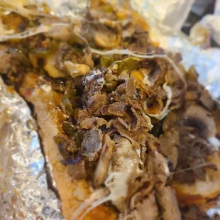 a pulled pork sandwich wrapped in foil