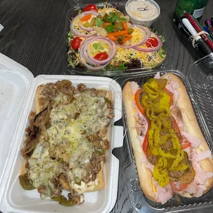 Flip&apos;s Signature Jerk Chicken Salad (top container), Flippin Turkey Hoagie (bottom right), Flippin Chicken Philly Sandwich (bottom left)