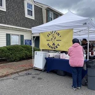  a woman standing under a tent