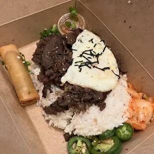 Bulgogi beef on rice with over easy egg and lumpia