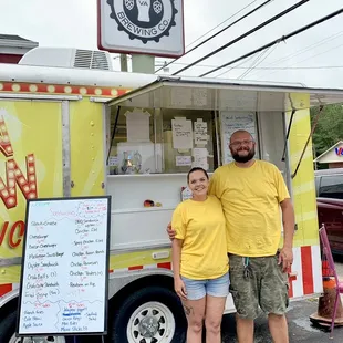 Owners with menu beside the "Flippen Yellow Truck"