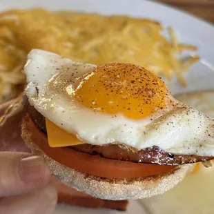 Another sunny side egg on top of English muffin, ham (from ham and eggs plate), sliced tomatoes, and slice of American cheese!