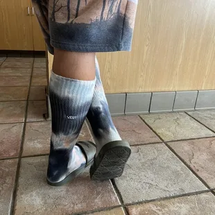 a person standing on a tile floor